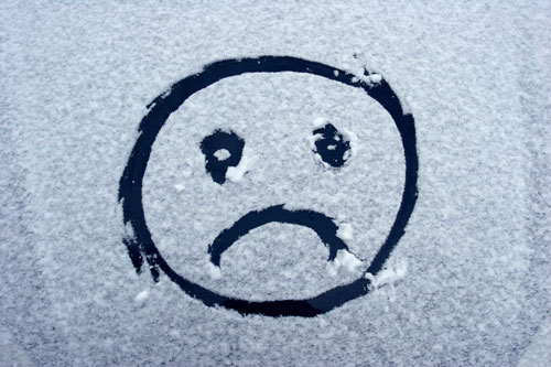 Sad face in winter snow